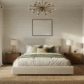 Photorealistic interior of a serene primary bedroom at golden hour, featuring a king-sized bed with ivory linen, textured pillows, walnut nightstands with brass lamps, and a jute rug. Sheer curtains billow softly, and a macramé wall hanging decorates the headboard. The warm light from a modern chandelier enhances the cinematic atmosphere, captured from a doorway perspective.