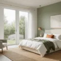 Photorealistic interior of a serene master bedroom featuring a king-sized bed, oatmeal linen headboard, white bedding with sage green and terracotta throws, warm white and sage green walls, light oak flooring with a jute rug, accent chairs, and stylish lighting, all bathed in soft morning sunlight.